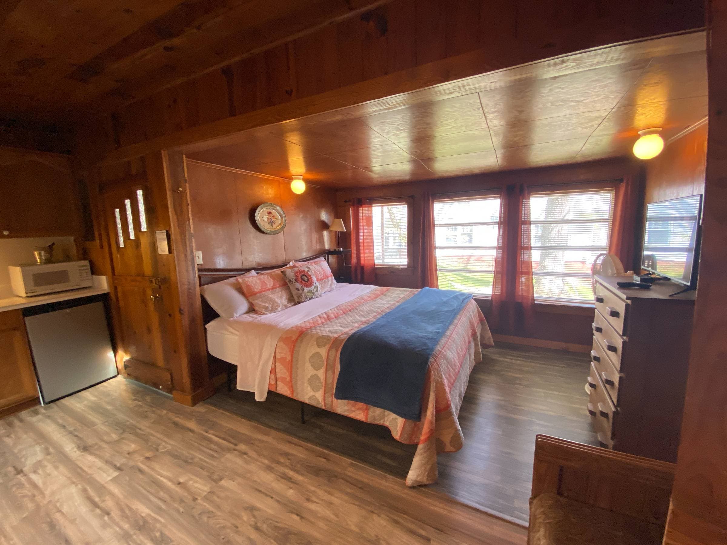 King bed with a view of the lake as you lie in bed.