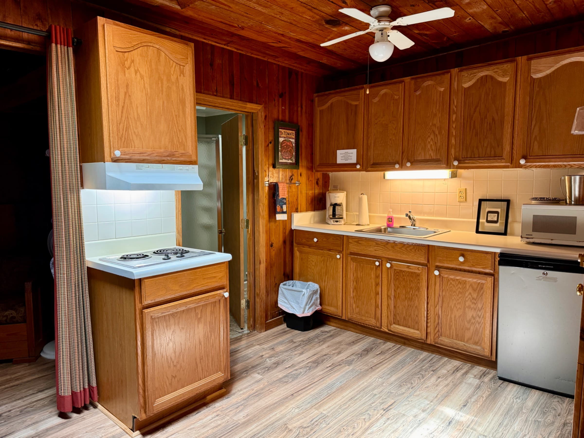  Kitchenette with two plate burner, microwave, coffee pot and filters, toaster, under counter fridge, pots and utensils 