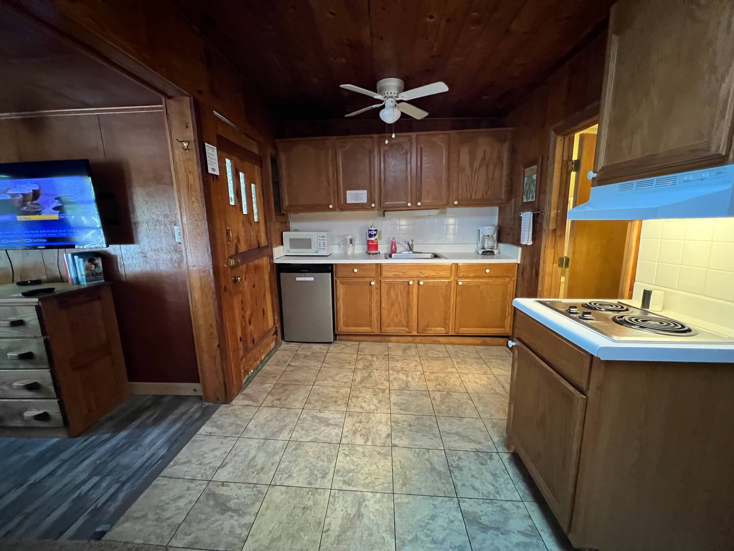  Kitchenette with two plate burner, microwave, coffee pot and filters, toaster, under counter fridge, pots and utensils 