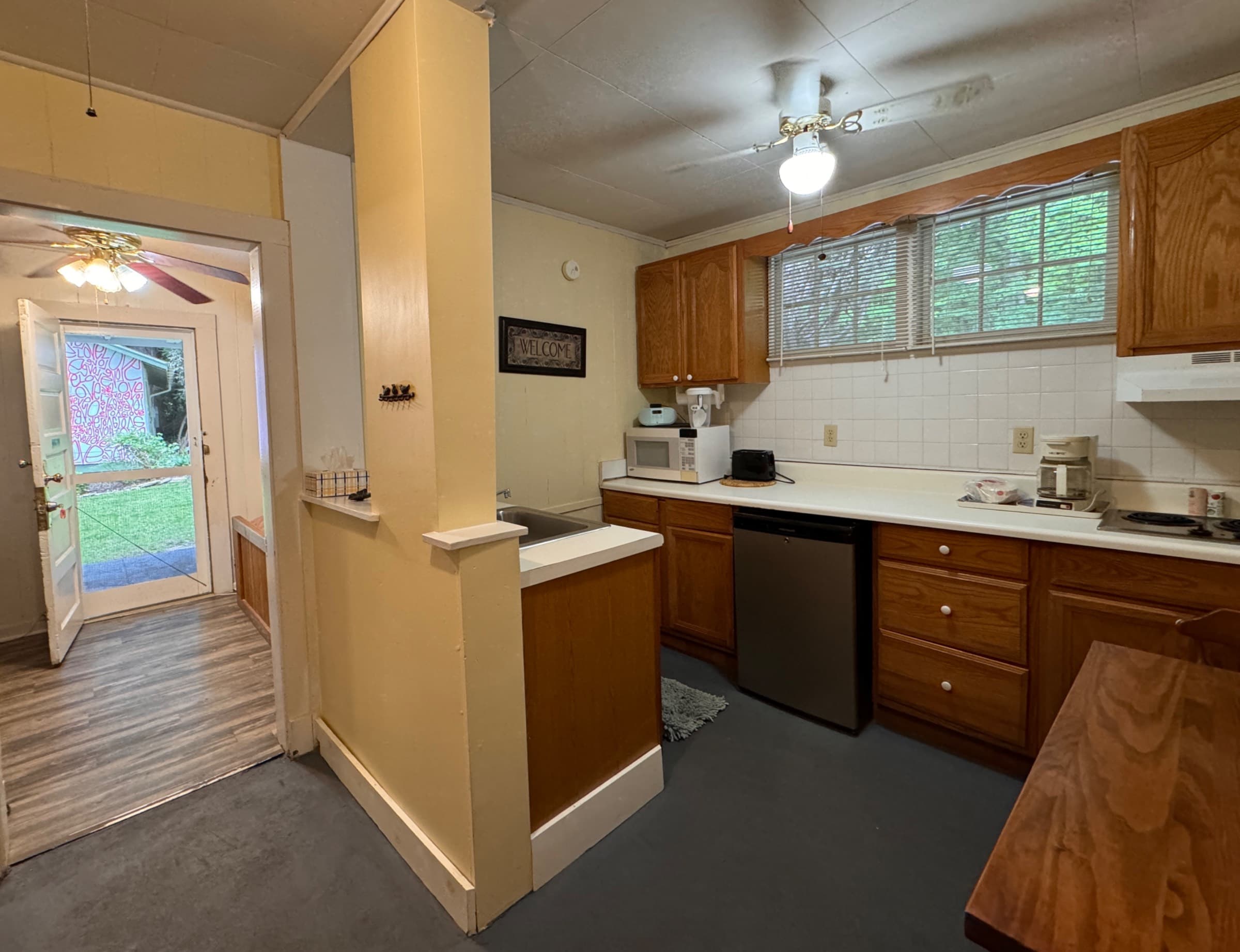  Kitchenette with two plate burner, microwave, coffee pot and filters, toaster, under counter fridge, pots and utensils 